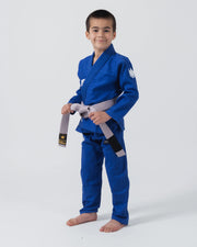 Kingz Kore V2 Youth BJJ Gi Blue - Full Body Angled Front View Young Athlete Gray Belt Crown Logo Sleeve Youth Kids