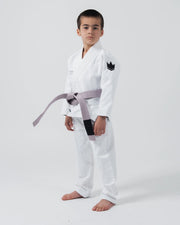 Kingz Kore V2 Youth BJJ Gi White - Full Body Angled Front View Young Athlete Gray Belt Crown Logo Right Sleeve Youth Kids Gi