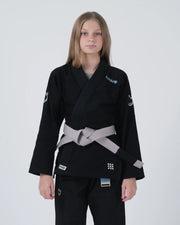Kingz Nano 3.0 Youth BJJ Gi Black - Upper Body Front View Girl Athlete Gray Belt NANO Text Crown Logo 380gsm Youth Kids Size