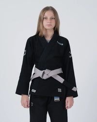 Kingz Nano 3.0 Youth BJJ Gi Black - Upper Body Front View Girl Athlete Gray Belt NANO Text Crown Logo 380gsm Youth Kids Size