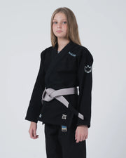Kingz Nano 3.0 Youth BJJ Gi Black - 3/4 Angled Upper Body View Girl Athlete Gray Belt Crown Logo NANO Text Youth Kids Size