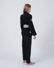 Kingz Nano 3.0 Youth BJJ Gi Black - Full Body 3/4 Back View Girl Athlete Gray Belt Crown Logo KINGZ Badge Youth Kids Nano Gi