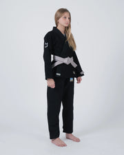 Kingz Nano 3.0 Youth BJJ Gi Black - Full Body Angled Front View Girl Athlete Gray Belt Crown Logo KINGZ Text NANO Badge Youth Kids