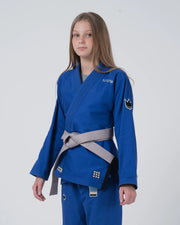 Kingz Nano 3.0 Youth BJJ Gi Blue - Upper Body 3/4 Angled View Girl Athlete Gray Belt Crown Logo NANO Text Youth Kids Size