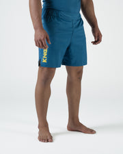 Kingz MI-K Roots Shorts Blue - Full Body Right Side Profile Male Athlete Steel Blue KINGZ Gold Text Left Leg Visible Side Split Competition Cut Men's Grappling Shorts No-Gi BJJ