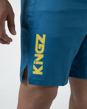 Kingz MI-K Roots Shorts Blue - Close Up Leg Detail KINGZ Large Bold Gold Yellow Text Left Leg Steel Blue Teal Fabric Side Split Visible Branding Detail Men's Grappling Shorts No-Gi BJJ MI-K Roots