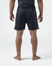 Kingz MI-K Roots Onça Pintada Shorts Black - Full Body Back View Male Athlete Dark Charcoal Black MI-K Waistband Text Back Side Split Visible Competition Cut Men's Grappling Shorts No-Gi BJJ