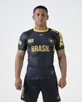 Kingz MI-K Roots Onça Pintada Rashguard Midnight Gray - Full Body Front View Male Athlete Short Sleeve BRASIL Gold Text Brazil Flag Crown Logo Jaguar Pattern Gold Collar KINGZ Shorts