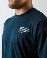Kingz Immersion Tee Navy - Close-Up Side View Male Athlete White Text Left Chest Jiu Jitsu Lifestyle Immerse Yourself Kingz Kimonos Soft Cotton Casual Fit Streetwear [color:Navy]