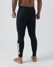 Kingz Kore Grappling Spats Black - Full Body Back View Shirtless Tattooed Male Athlete All-Black KINGZ Large Bold White Vertical Text Right Calf Men's No-Gi BJJ Spats Kore Collection