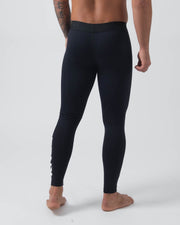Kingz Kore Grappling Spats Black - Full Body Right-Back Side Profile Shirtless Tattooed Male Athlete All-Black KINGZ White Vertical Text Right Calf Men's No-Gi BJJ Spats Kore Collection
